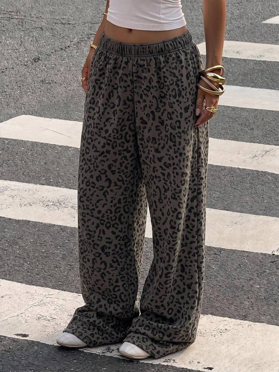 Dark grey leopard print trousers styled with a white top and trainers
